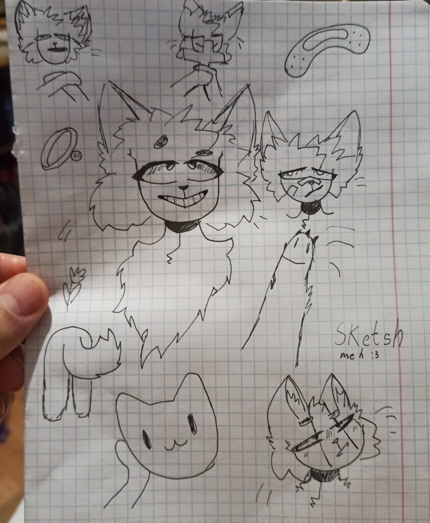 Dibujo de gatos en una hoja de libreta de escuela. El dibujo realizado durante la invasión de Rusia a Ucrania